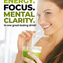 Smiling woman holding a glass of green superfood drink with a straw; text reads “Energy. Focus. Mental Clarity. In one great tasting drink!”